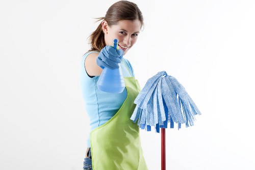 Carpet cleaning team working safely in a home with protective equipment